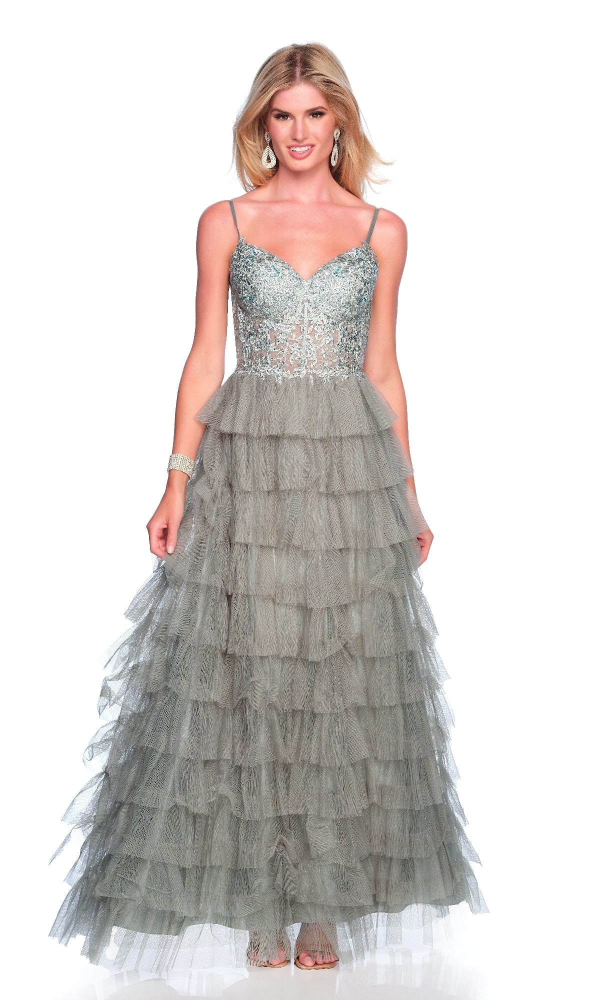 A woman models the Dave and Johnny 12053 long prom dress—a sleeveless, silver-blue gown with an embroidered bodice and ruffle tiered skirt—styled with earrings and a bracelet against a white background.